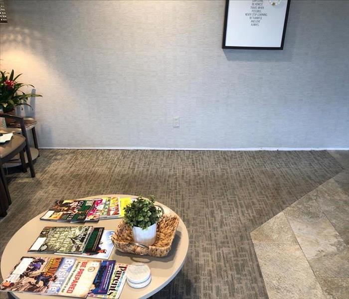 Dental waiting room carpet is dried. Coffee table with magazines on it.