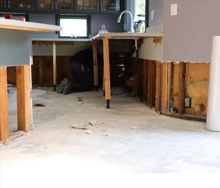 water damage to kitchen flooring and walls. Demo'd walls up about 6 inches and removed flooring.