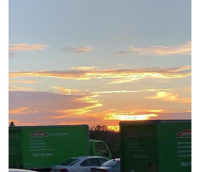 Sunset with green trucks.