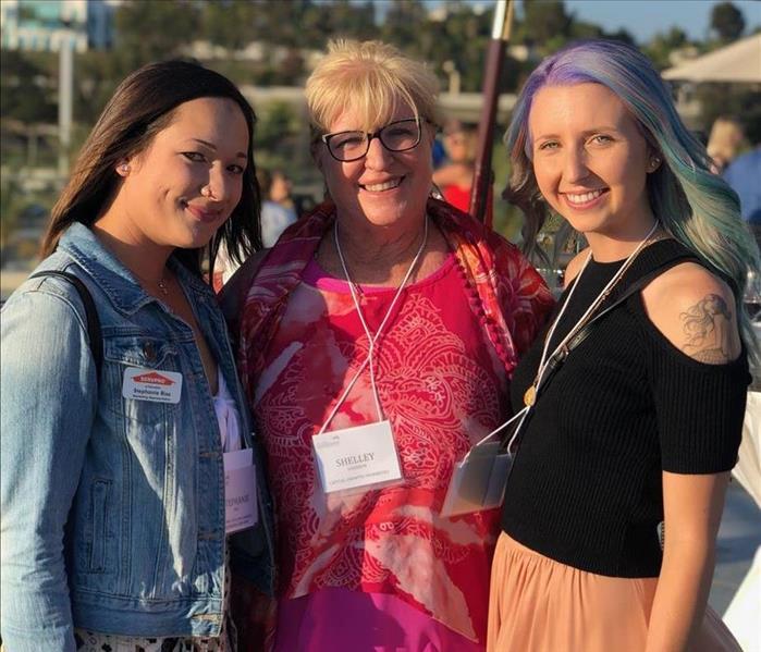 Three women at a property management event.