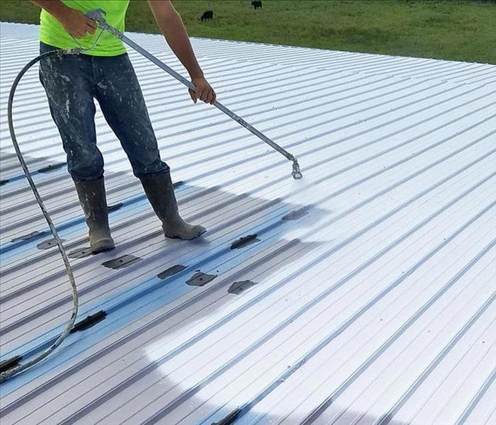 Person sealing roof