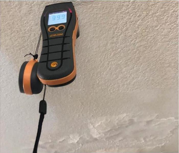 Meter checking wetness on wall