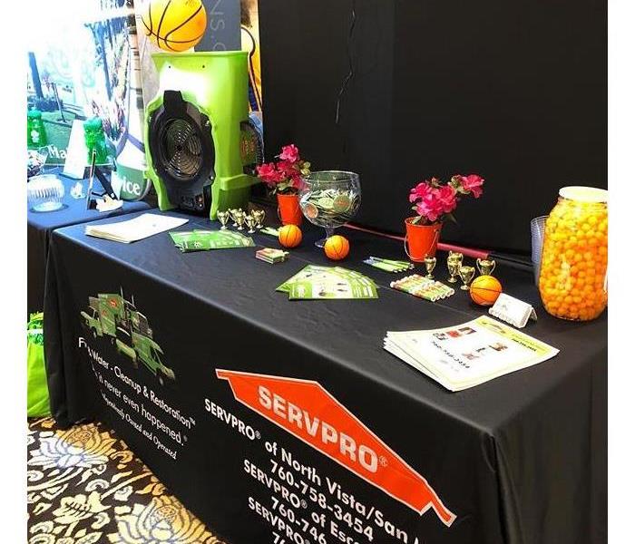 Table with marketing supplies at a trade show.